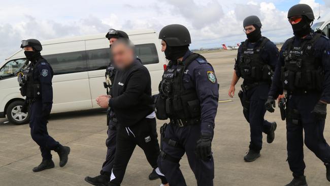 Security was high was Sam Ibrahim was escorted to a plane at Sydney airport on Thursday morning. Pictures: NSW Police