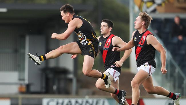 Kieran Lovell gets a kick away for the Tigers. The ball magnet copped strong attention from Blade Sulzberger for most of the game. Picture: Nikki Davis-Jones