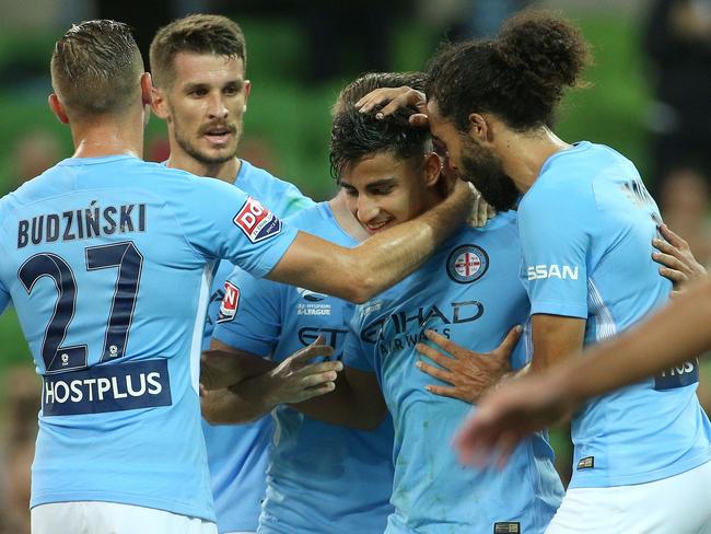 City players swamp Daniel Arzani.