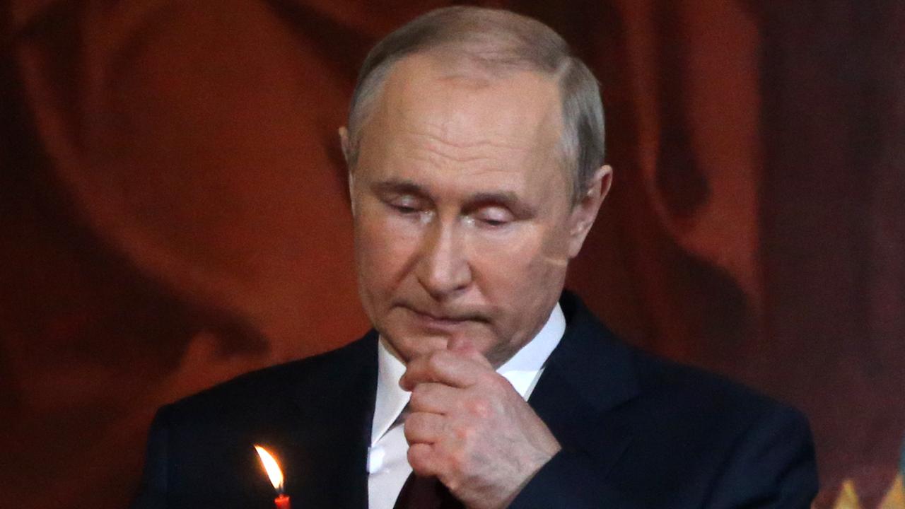 Putin fidgeted and seemed distracted while standing near the altar. Picture: Contributor/Getty Images