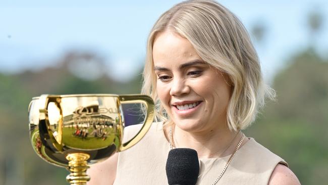 MELBOURNE, AUSTRALIA - NOVEMBER 04: Jockey Winona Costin who takes her first ride in the Melbourne Cup aboard Positivity speaks during a Melbourne Cup Media Call in front of the finishing post at Flemington Racecourse on November 04, 2024 in Melbourne, Australia. (Photo by Vince Caligiuri/Getty Images)