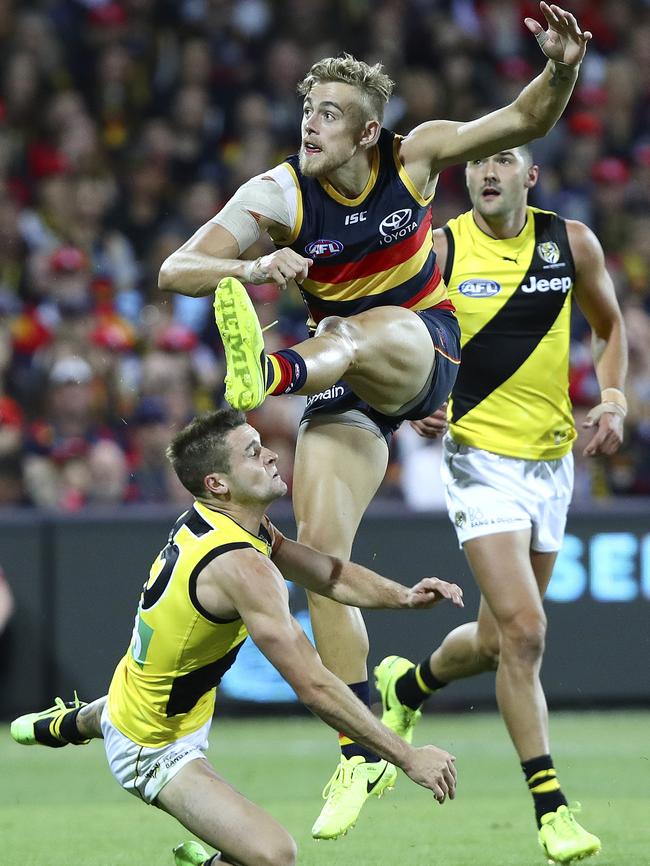 Hugh Greenwood snaps a goal over Richmond’s Jayden Short on Thursday. Picture SARAH REED.