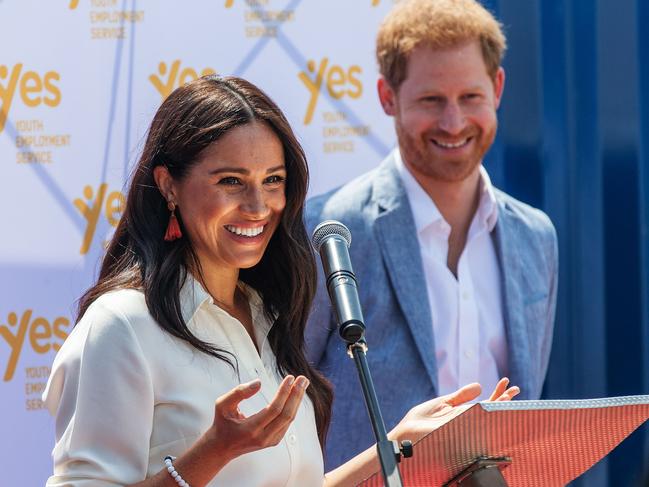 Meghan, Duchess of Sussex(L), is watched by Britain's Prince Harry, Duke of Sussex(R) as  she delivers a speech at the Youth Employment Services Hub in Tembisa township, Johannesburg, on October 2, 2019. - Meghan Markle is suing Britain's Mail On Sunday newspaper over the publication of a private letter, her husband Prince Harry has said, warning they had been forced to take action against "relentless propaganda". (Photo by Michele Spatari / AFP)