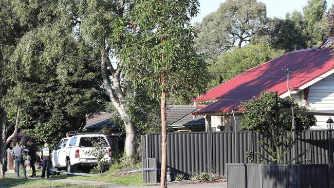 Detectives outside the home.