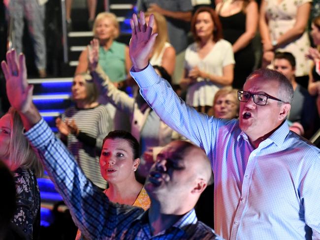 *This picture has been selected as one of the Best of the Year News images for 2019* Prime Minister Scott Morrison and wife Jenny sing during an Easter Sunday service at his Horizon Church at Sutherland in Sydney, Sunday, April 21, 2019. (AAP Image/Mick Tsikas) NO ARCHIVING