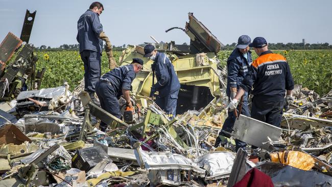 Ukrainian rescue workers inspect part of the wreckage of Malaysia Airlines flight MH17 in July, 2014. Picture: Getty Images