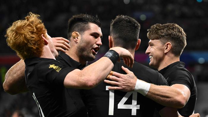 (From L to R) New Zealand's fly-half Finlay Christie, New Zealand's number eight Luke Jacobson, New Zealand's right wing Will Jordan and New Zealand's full-back Beauden Barrett celebrate a try during the France 2023 Rugby World Cup Pool A match between New Zealand and Uruguay at the OL Stadium in Decines-Charpieu, near Lyon, south-eastern France, on October 5, 2023. (Photo by SEBASTIEN BOZON / AFP)
