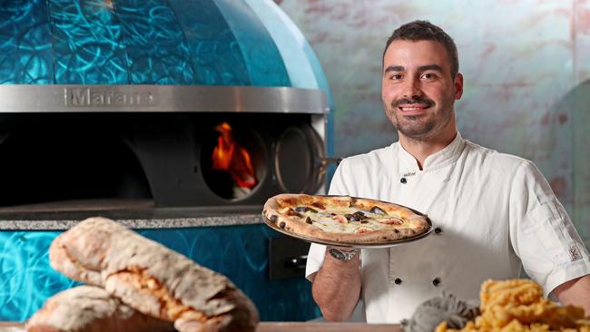 Head Chef and Owner Lewis Marro with a Bizarre Cheese pizza and his new Marana Forni wood fire pizza oven at Farina 00 on King William Road. Picture: Dylan Coker