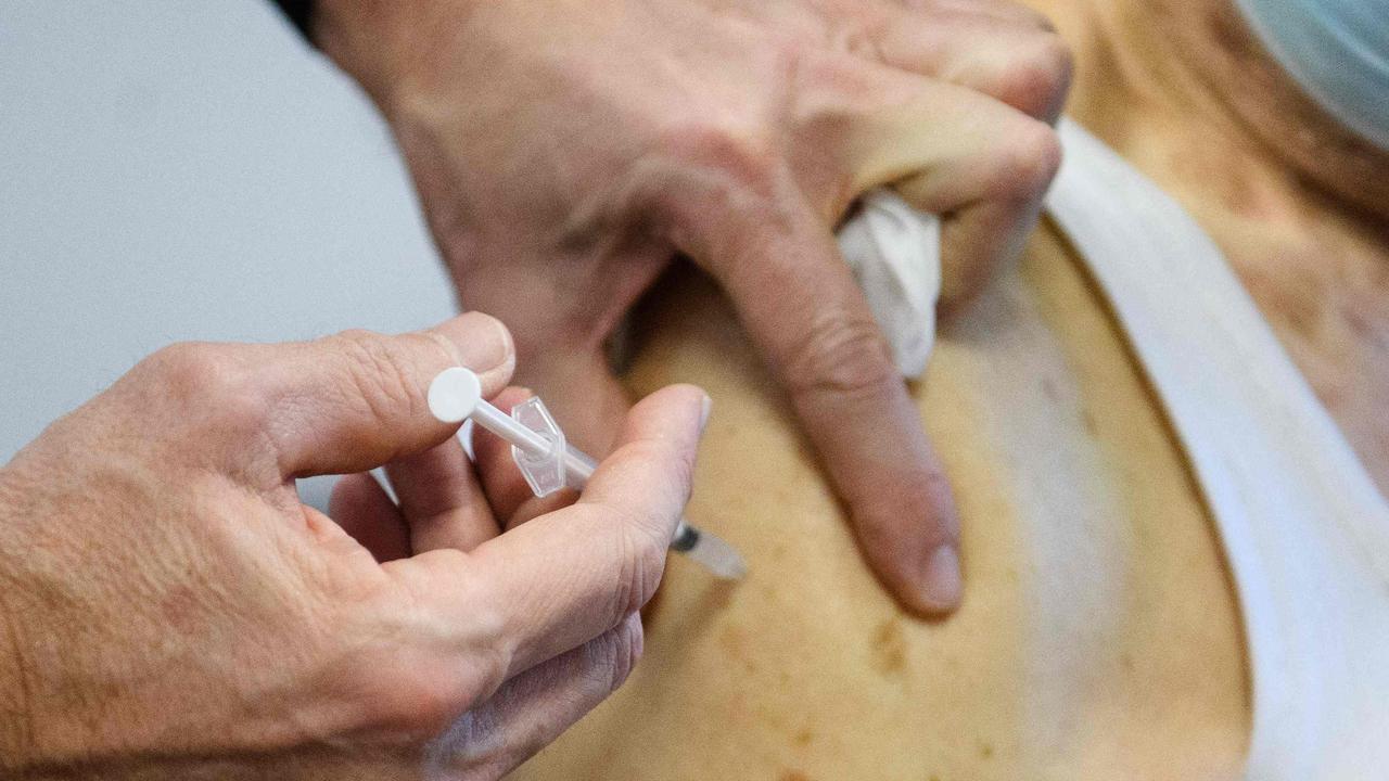 A man, wearing a protective face mask, receives a dose of Pfizer. Picture: AFP