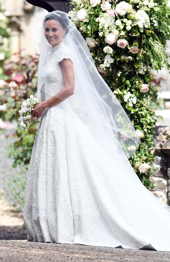 Pippa beams as she smiles for cameras in her Giles Deacon gown.