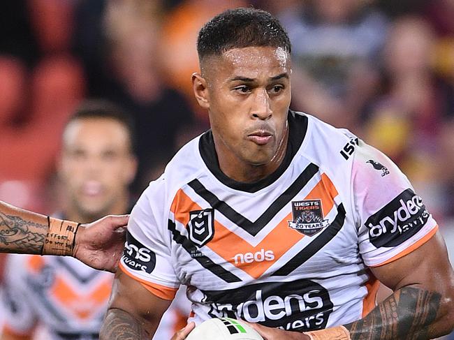 Michael Chee Kam of the Tigers (centre) on his way to scoring the winning try in the Round 5 NRL match between the Brisbane Broncos and the Wests Tigers at Suncorp Stadium in Brisbane, Thursday, April 11, 2019. (AAP Image/Dave Hunt) NO ARCHIVING, EDITORIAL USE ONLY