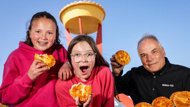 Melbourne Royal Show is back for another year — just look for the pie in the sky. Alyssa, 11, and Lola, 11, tuck into some Wonder Pies with chef Raymond Capaldi. Picture: Ian Currie