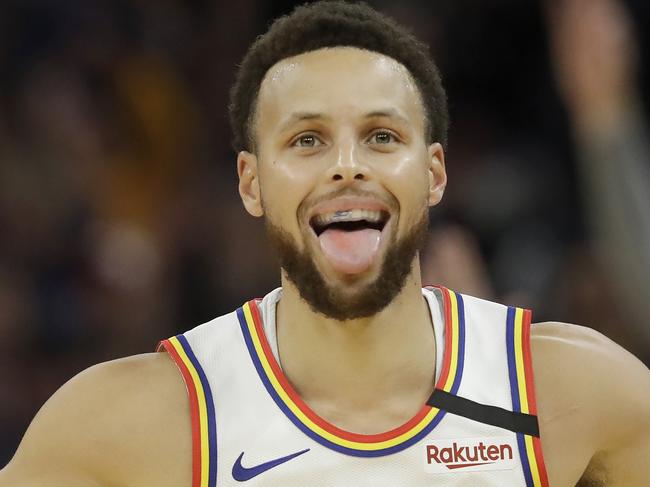 Golden State Warriors guard Stephen Curry (30) reacts after shooting a 3-point basket against the Toronto Raptors during the first half of an NBA basketball game in San Francisco, Thursday, March 5, 2020. (AP Photo/Jeff Chiu)