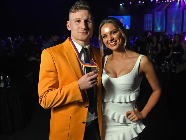 Rory Laird with partner Lucy McArthur dons the yellow jacket and proudly shows his Malcolm Blight Medal at the Adelaide Entertainment Centre. Picture: Tom Huntley