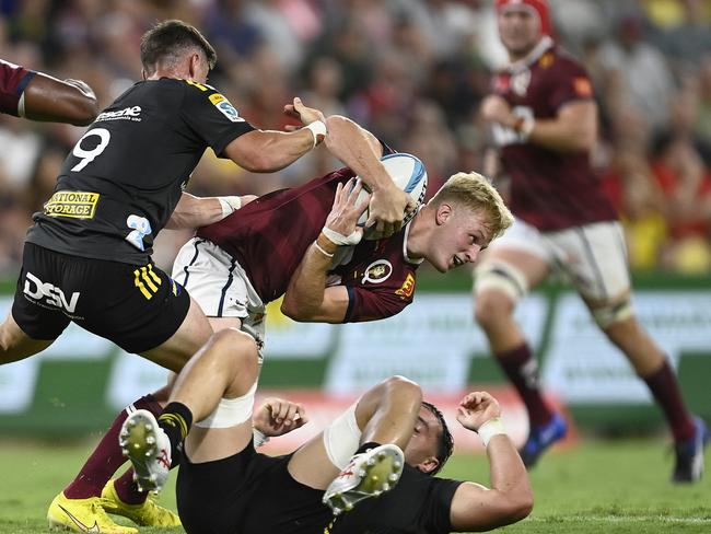 Tom Lynagh attempts to break away from the Hurricanes’ defence. Picture: Ian Hitchcock / Getty Images