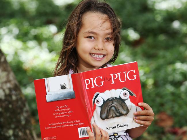 Saphira Chibnall, 5, reading Pig the Pug.