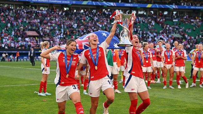 Australia’s golden girls are cheered on by their Arsenal teammates as they raise the trophy to the crowd.