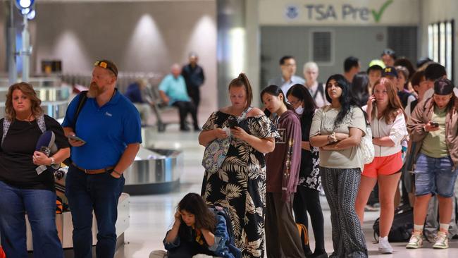 Travellers wait in a long line to check with Delta airline representatives as to where their luggage is at the Detroit Metropolitan Wayne County Airport on July 20. Picture: Getty