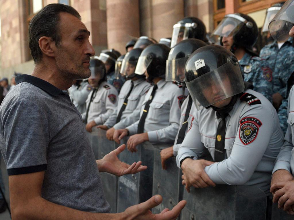 A protester speaks with Armenian police officers as they guard the entrance to the Government House during a rally in Yerevan on September 21, 2023. Picture: AFP