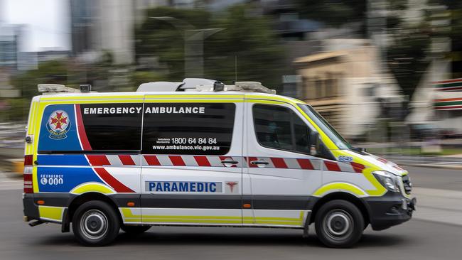 MELBOURNE, AUSTRALIA - NewsWire Photos FEBRUARY 13, 2022: An ambulance speeds away from the Royal Melbourne Hospital. Ambulance, Generic.Picture: NCA NewsWire / David Geraghty