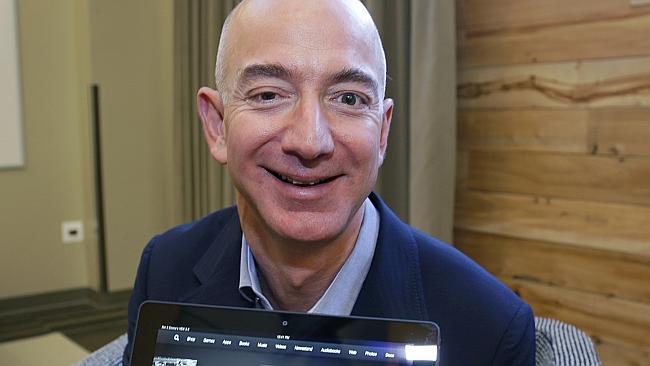 FILE - In a Sept. 24, 2013, file photo Jeff Bezos, CEO of Amazon.com, holds the 8.9-inch version of the new Amazon Kindle HDX...