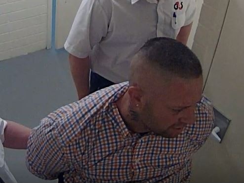 Daniel James Nicholson, who jumped the dock at Christies Beach Magistrates Court . Being escorted by officers in Sept 2020. Picture: Courts SA