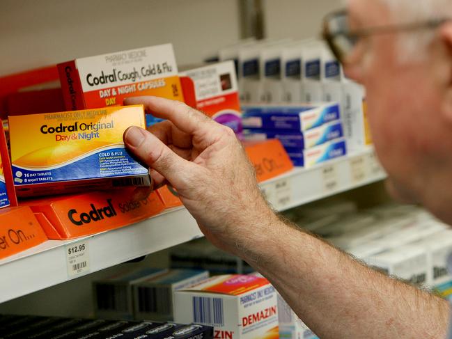 Pharmacist John Bell views a packet of codral containing pseudoephedrine at a pharmacy in Sydney. The government want to introduce an alternative chemical which is less effective.