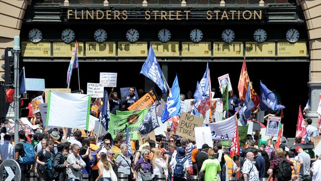 Public transport staff hold a stop-work meeting outside Flinders Street Station. Picture: Andrew Henshaw