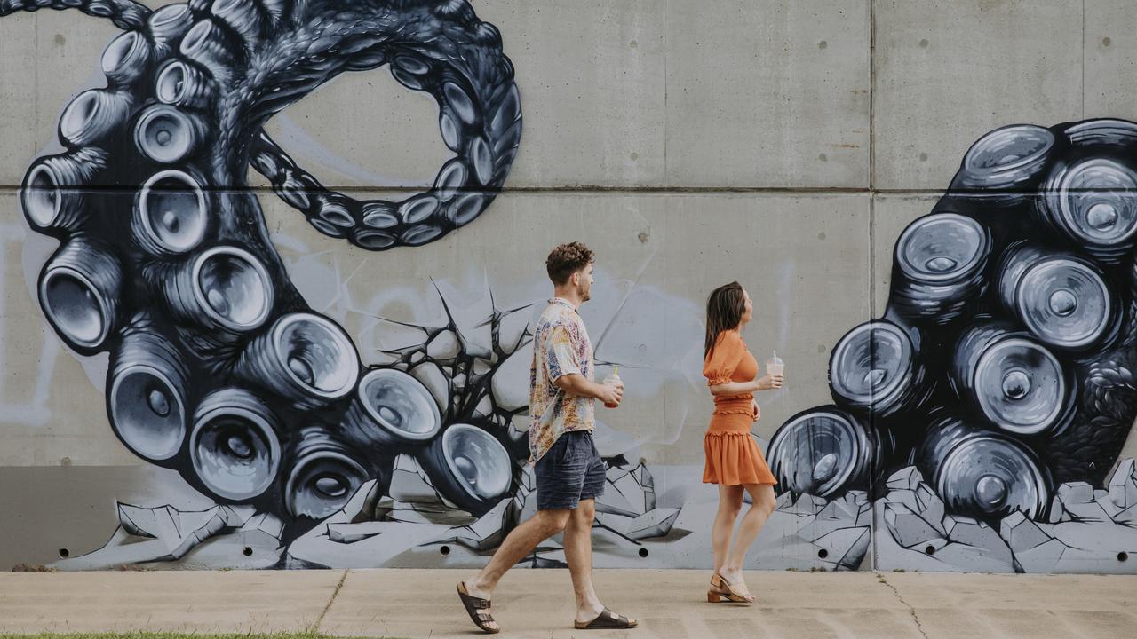 A couple explore street art in Yeppoon. Picture: Jack Harlem