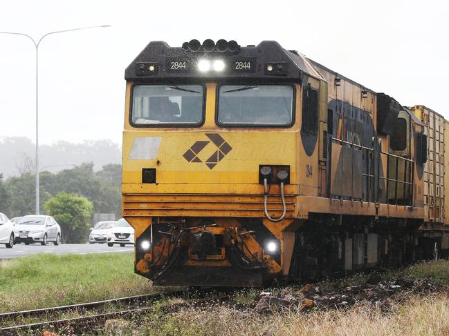 An Aurizon freight train loaded with cargo heads south along the railway tracks at Woree, south of Cairns. PICTURE: BRENDAN RADKE