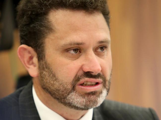 Committee chairman Kyam Maher questions freed murder suspect Henry Keogh during a South Australian parliamentary inquiry at Parliament House in Adelaide, Monday, November 5, 2018. Mr Keogh, who spent more than 20 years in jail for the 1994 murder of Anna-Jane Cheney, on Monday gave evidence to the inquiry, which is looking at the basis for the payment. (AAP Image/Kelly Barnes) NO ARCHIVING