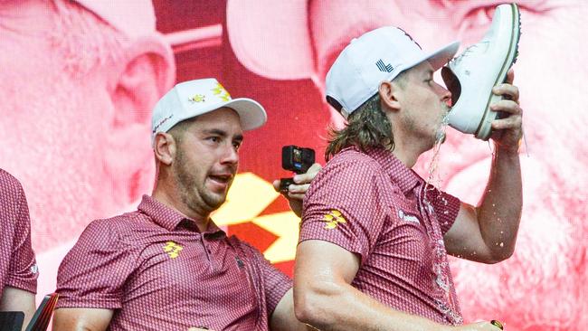 Australia's Lucas Herbert (L) of Ripper GC watches teammate Cameron Smith doing a shoey as they celebrate winning the team competition. Picture: Brenton Edwards.