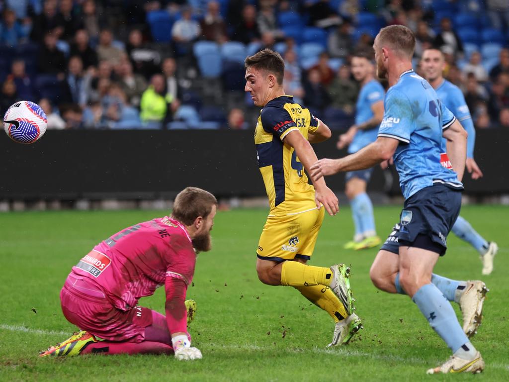 Mariners star Joshua Nisbet gets the ball past Sydney FC goalkeeper Andrew Redmayne to score a goal during the A-League Men Semi Final. Picture: Getty Images