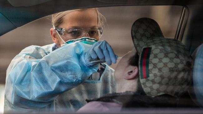 Royal Australian Air Force medical assistant Georgia Smith conducts a coronavirus test in Melbourne. Picture: Supplied.