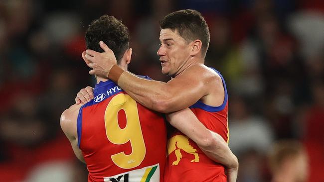 Dayne Zorko celebrates a goal with Brownlow Medal favourite Lachie Neale.