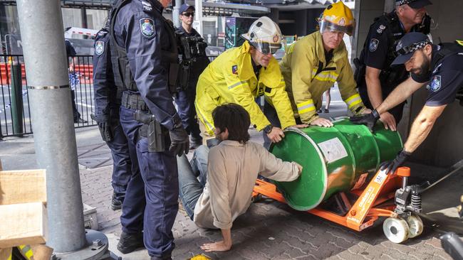 This Brisbane activist thought if he cemented his arm into a 44-gallon drum, the police couldn’t take him away. Picture: AAP Image/Glenn Hunt