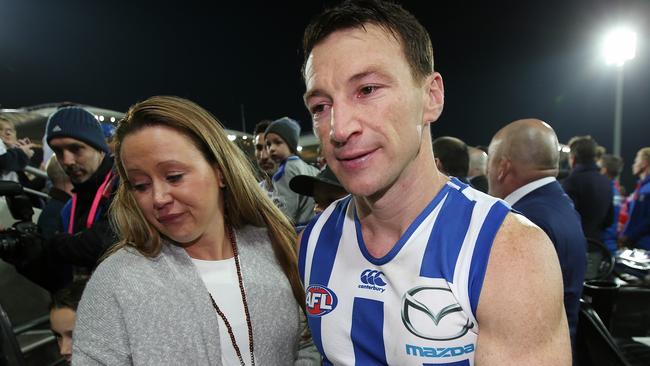 An emotional Brent Harvey and his wife Shayne after his final game for North Melbourne. Picture: Michael Klein