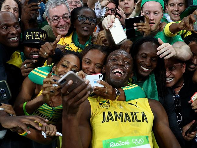 RIO DE JANEIRO, BRAZIL - AUGUST 18: Usain Bolt of Jamaica celebrates with fans after winning the Men's 200m Final on Day 13 of the Rio 2016 Olympic Games at the Olympic Stadium on August 18, 2016 in Rio de Janeiro, Brazil. (Photo by Ryan Pierse/Getty Images)