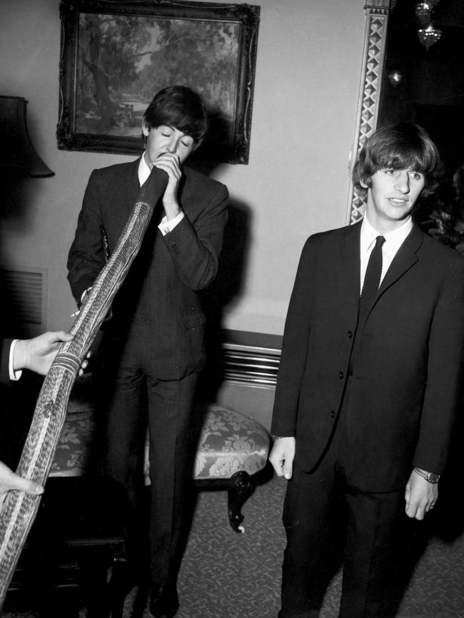 Paul McCartney tries out a didgeridoo at the Melbourne Town Hall. Picture: Herald Sun Image Library