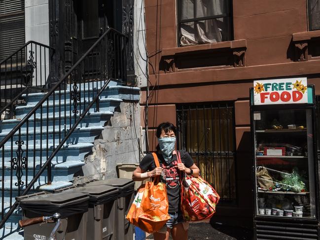 A New Yorker loads up from a free food refrigerator in Brooklyn. Picture: Getty Images/AFP