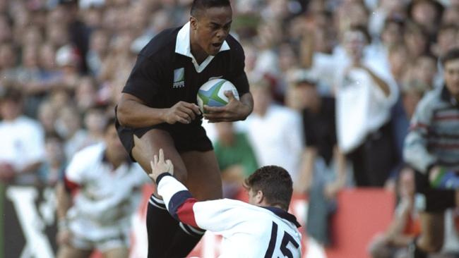 Jonah Lomu used England fullback Mike Catt as a speed bump in the semi-final. Picture: Ben Radford/Allsport