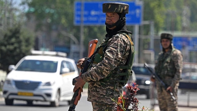 Indian paramilitary troopers stand guard along a street in Srinagar. Picture: AFP