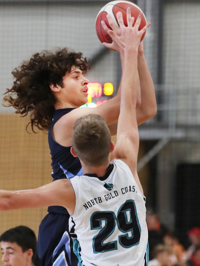 Basketball Queensland Under-16 Boys State Championships at the Coomera Indoor Sports Centre.Northside Wizards (Navy) v North Gold Coast Seahawks . Wizards Kaylan Jackson soars over Seahawks Liad Kagan Picture Glenn Hampson