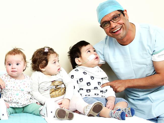 Surgeon Dr Gordon Thomas and his team recently completed 11 transplants in just four weeks. Dr Thomas with some of those recipients Taylor, 1, Alexa, 9 months, Lital, and Patrick. Picture: Tim Hunter