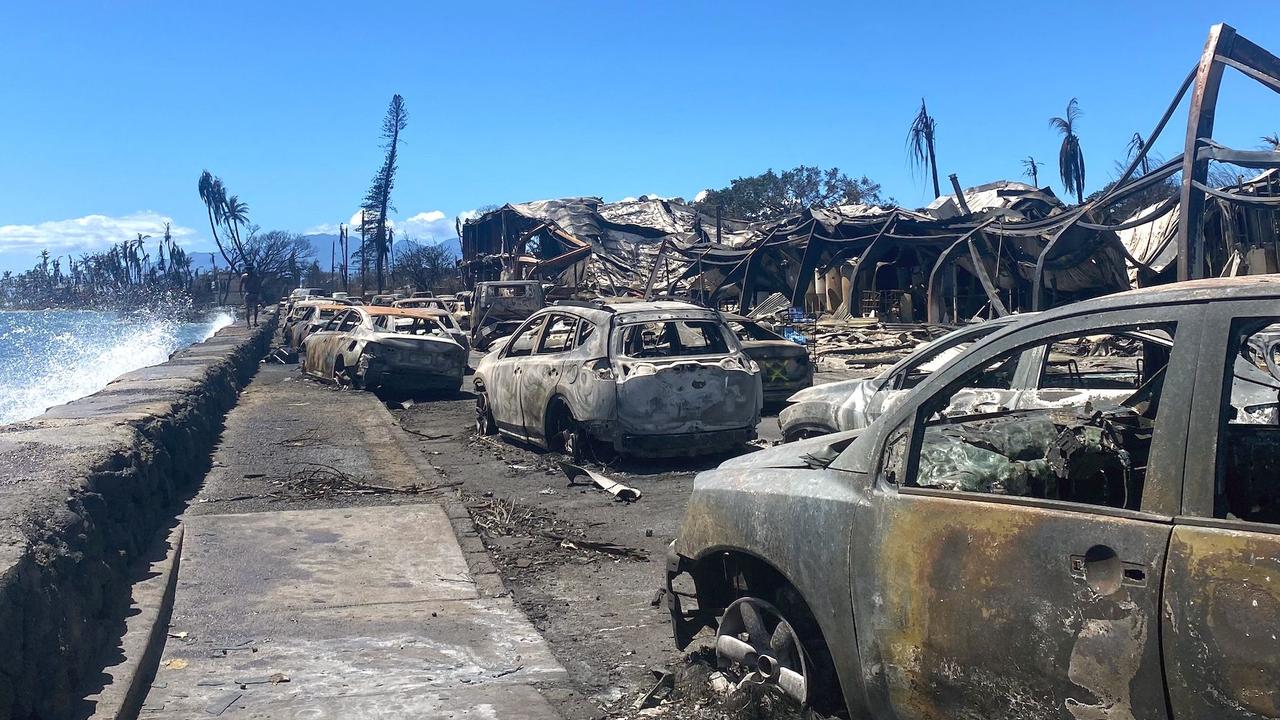 Burned cars and destroyed buildings are pictured in the aftermath of a wildfire in Lahaina, western Maui, Hawaii on August 11, 2023. (Photo by Paula RAMON / AFP)