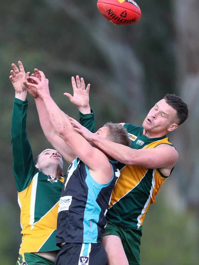 Dookie United’s Ben Dyer is sandwiched in a marking contest with Murchison-Toolamba pair Tom Kerrins and Jayedo Hexter.