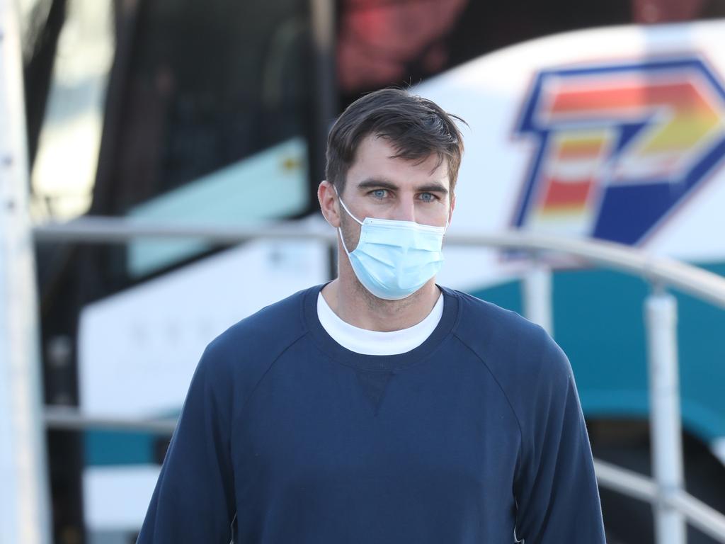 Pat Cummins arrive at Sydney Airport to be transported by bus to a quarantine hotel. Picture: John Grainger