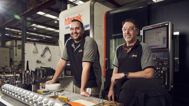 Workers Taylor Sumner and Tony Browning at Axiom Precision’s factory in Wingfield. Picture: MATT LOXTON