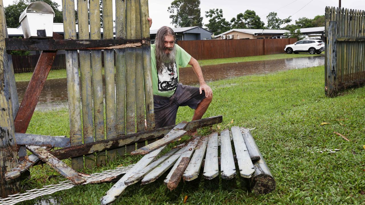 Klarwein Close resident Alan Stirling looks at the damage to his fence, after heavy rain caused flooding to some areas in Gordonvale, south of Cairns in Far North Queensland. Picture: Brendan Radke