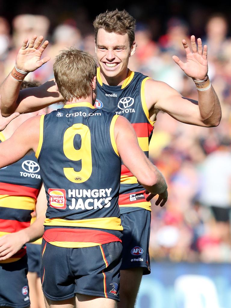 Thilthorpe celebrates a goal with Rory Sloane in round 1. Picture: AFL Photos via Getty Images